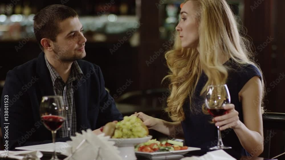 young pait talking in restaurant and celebrating young pait talking in restaurant and celebrating