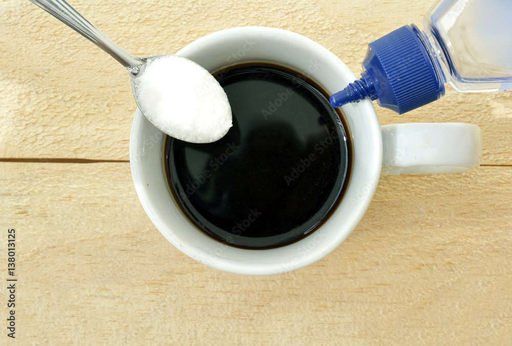 Ταπετσαρία Coffee cup on a wood table seen from high angle with a spoon with sugar on the l