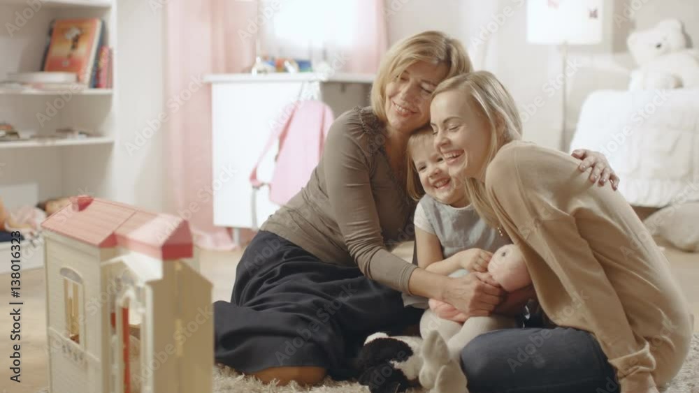 Grandmother, Mother and Her Little Cute Daughter have a Big Hug. They're in a Children's Room which is Pink and full of Toys. Shot on RED EPIC-W 8K Helium Cinema Camera. Grandmother, Mother and Her Little Cute Daughter have a Big Hug. They're in a Children's Room which is Pink and full of Toys. Shot on RED EPIC-W 8K Helium Cinema Camera.