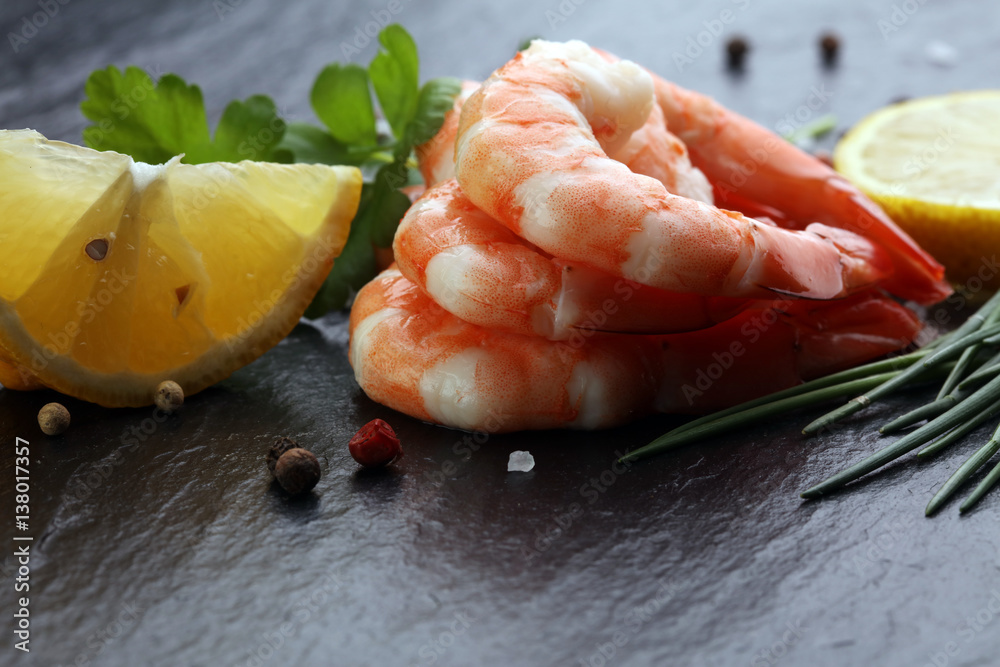 Delicious sauteed shrimp heart with cajun seasoning and lime on dark stone Delicious sauteed shrimp heart with cajun seasoning and lime on dark stone