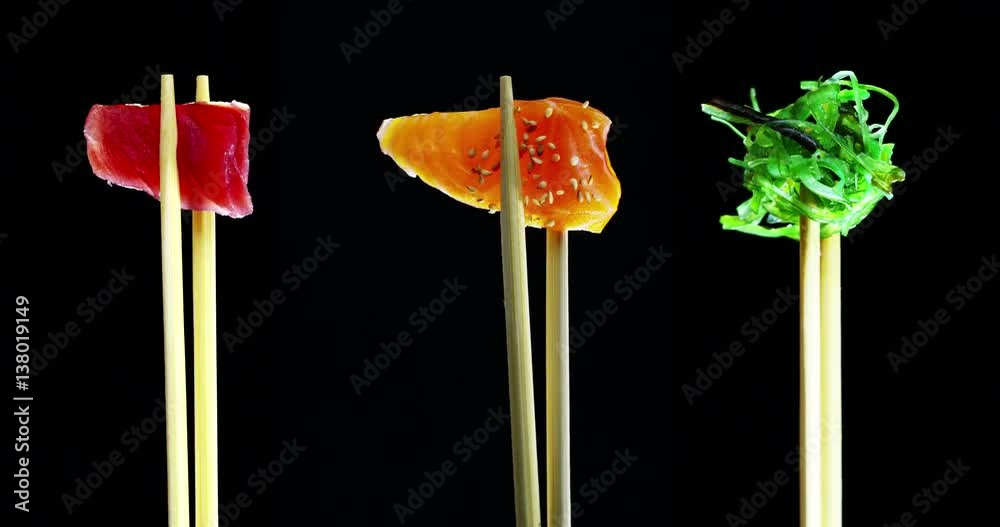 Macro shot of sushi,sashimi,uramaki and nighiri.typical Japanese dish consisting of rice, salmon or tuna,shrimp and fish eggs on a black background.Concept:Japanese restaurant,sushi,oriental tradition Macro shot of sushi,sashimi,uramaki and nighiri.typical Japanese dish consisting of rice, salmon or tuna,shrimp and fish eggs on a black background.Concept:Japanese restaurant,sushi,oriental tradition
