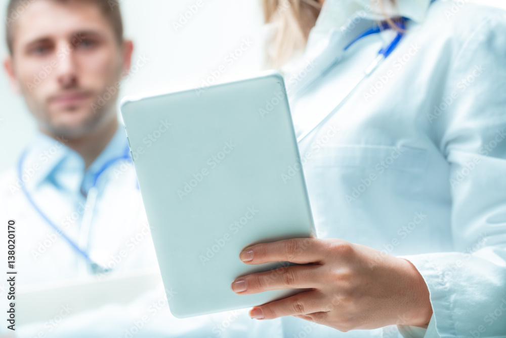 doctors thinking about exam's data with a tablet doctors thinking about exam's data with a tablet