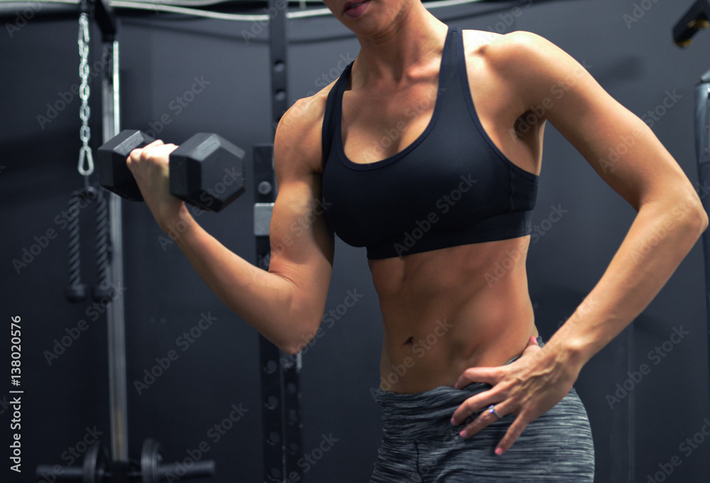 Woman athlete at the gym weight training to stay fit. Woman athlete at the gym weight training to stay fit.