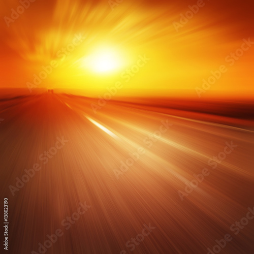 Asphalt road in motion blur at sunset.