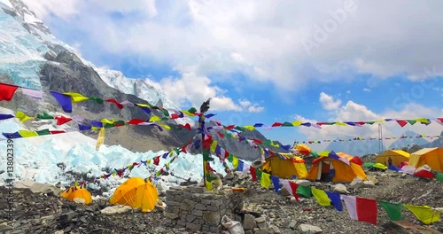 Everest Base Camp colored tents, at an altitude of 5,364 metres (17,598 ft). These camps are rudimentary campsites on Mount Everest that are used by mountain climbers during their ascent and descent.  photo