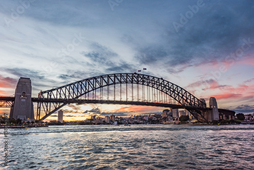 Australian iconic landmark Sydney Harbour Bridge against picturesque sunset sky © Olga K
