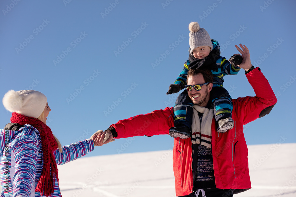 Attractive family having fun in a winter park on mountain Attractive family having fun in a winter park on mountain