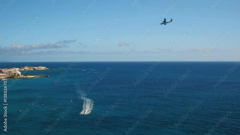 St Maartin Aerial v56 Flying low over bay panning with views of Simpson Bay and small plane landing. St Maartin Aerial v56 Flying low over bay panning with views of Simpson Bay and small plane landing.