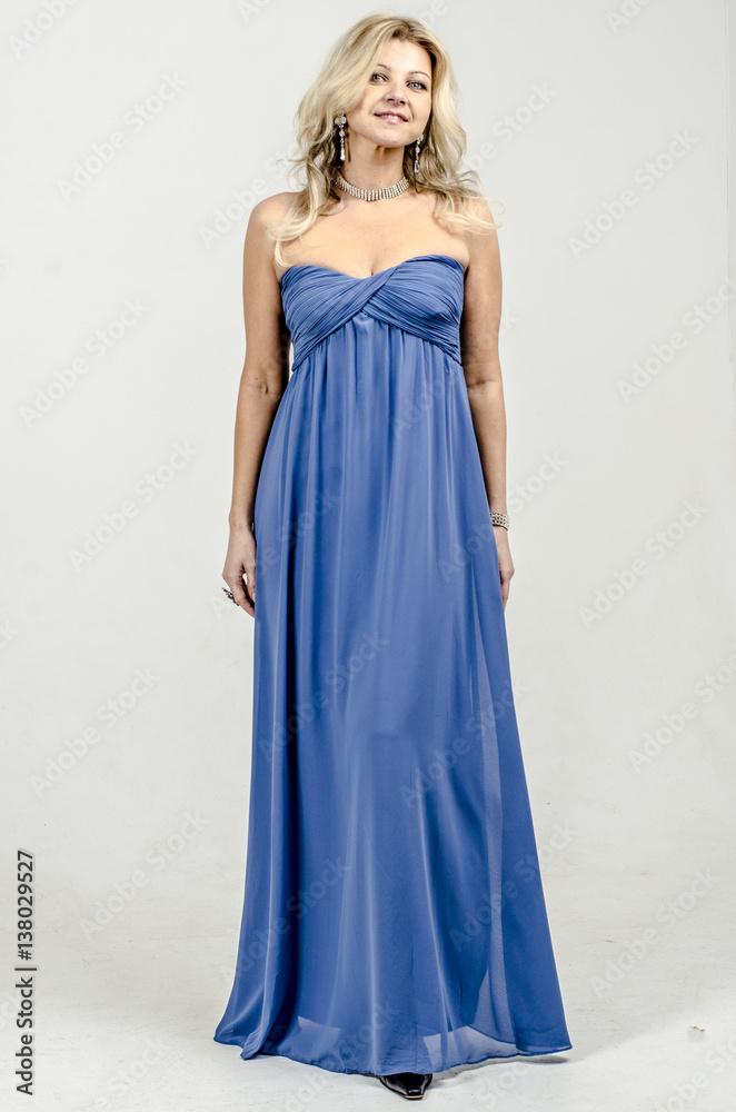Beautiful blonde woman in a blue cocktail dress
