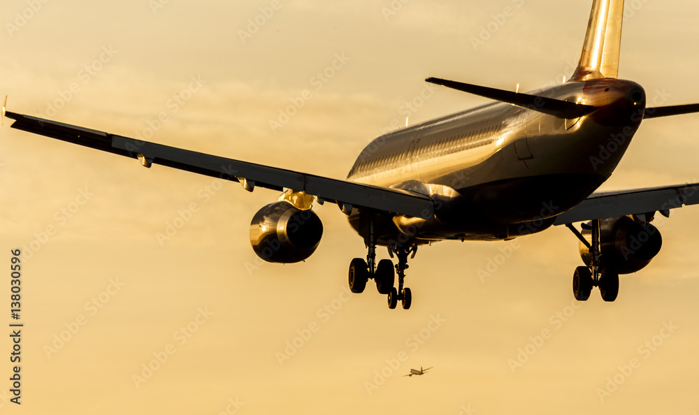 Fototapeta premium Passenger Jet Landing Approach at Sunset
