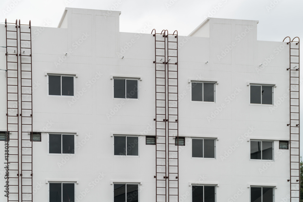 exterior of building with the fire escape.blue sky background