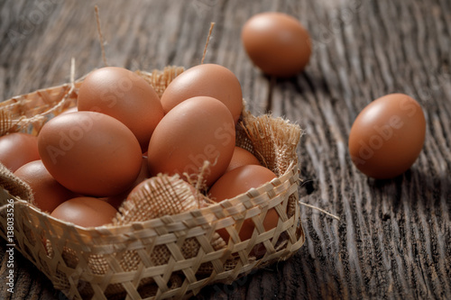 Brown Egg in a basket on wooden table, Chicken Egg