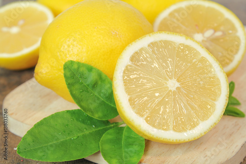 fresh lemon whole and slice with lemon leaf
