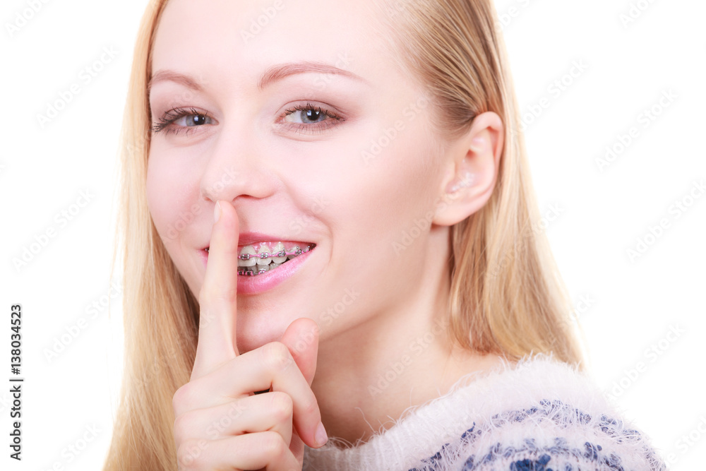 Young blonde woman making silence gesture Young blonde woman making silence gesture