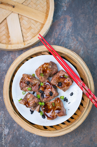 Steamed pork ribs  in a mambo steamer - traditional dim sum dish  photo