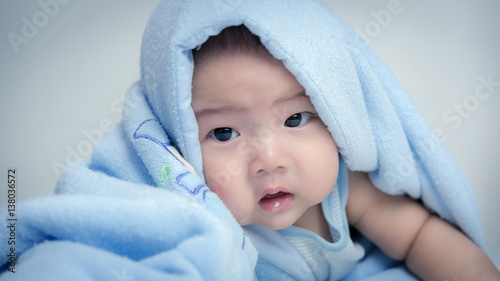 baby boy is hiding under the blue blanket,asian baby,baby in home