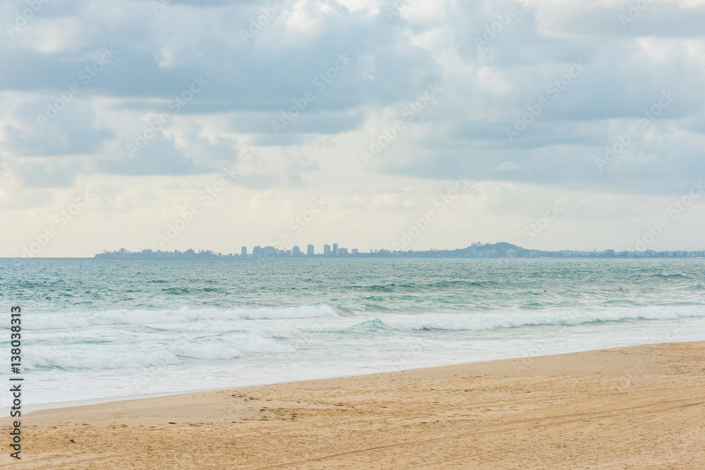 Surfers Paradise beach with distant cityscape on the horizon