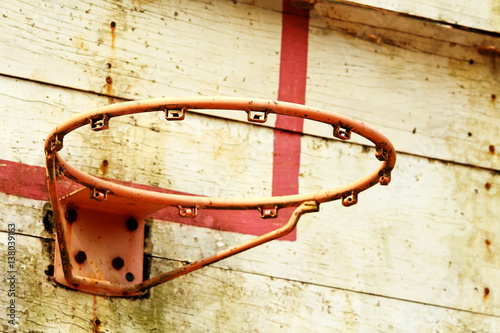 Old outdoor basketball hoop and backboard in rural school photo