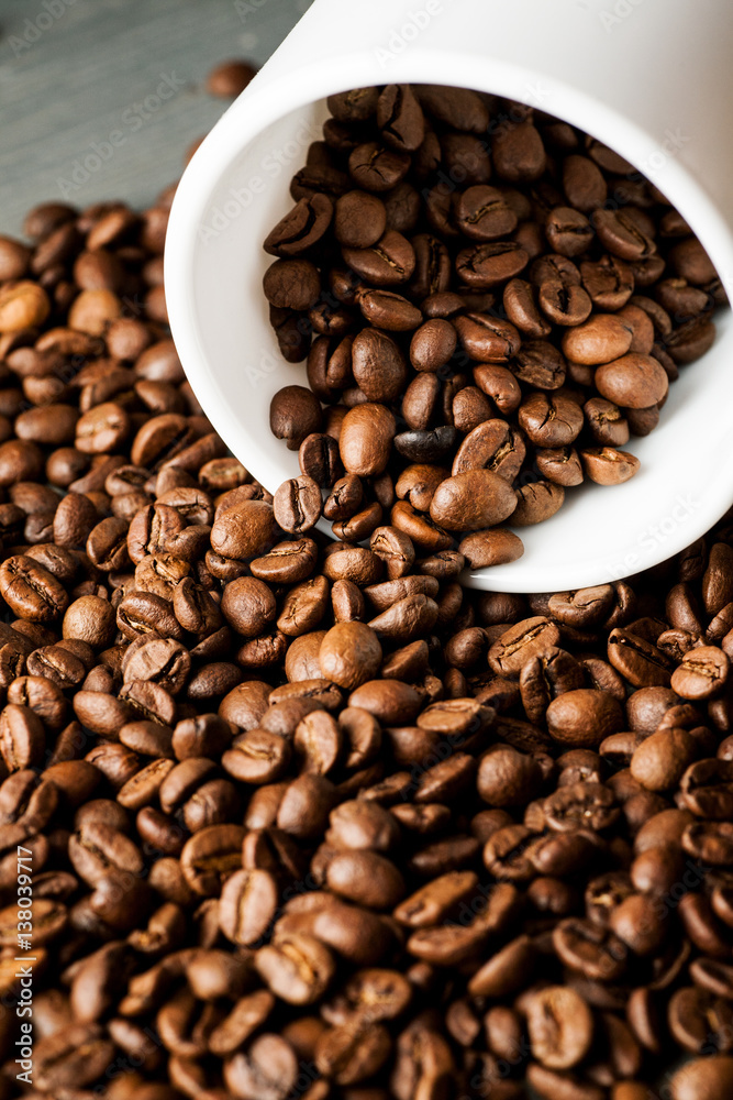 White ceramic mug with coffee beans on wooden table, vertical sot White ceramic mug with coffee beans on wooden table, vertical sot