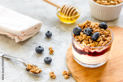 Healthy breakfast from yoghurt with muesli and berries on kitchen table
