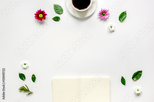 Copybook, americano and flowers on white table top view mock-up