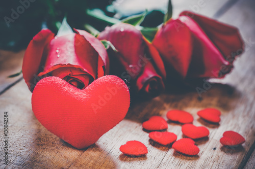 Red hearts and roses on wooden board.Valentines Day background concept, Wedding day.Vintage tone photo