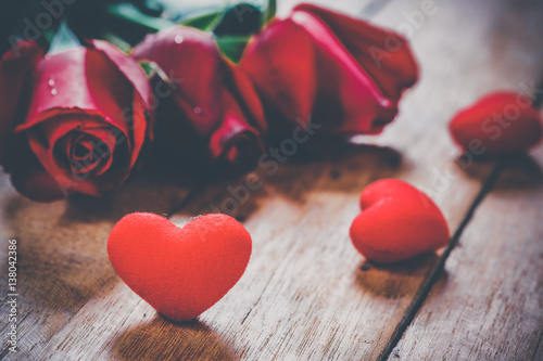 Red hearts and roses on wooden board.Valentines Day background concept, Wedding day.Vintage tone photo