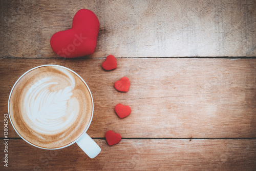 Heart and cup of coffee on wooden background with copy space.Valentines Day background concept, Wedding day.Top view vintage tone photo