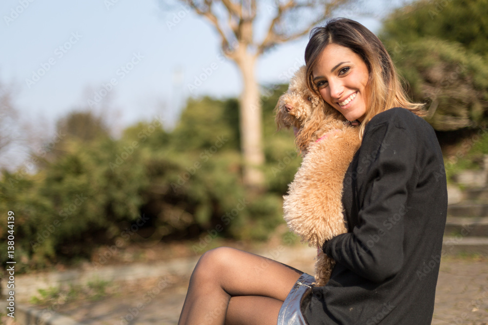 Beautiful young woman with her dog in a park Beautiful young woman with her dog in a park