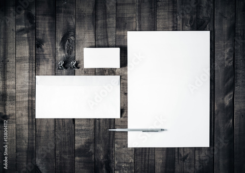 Blank stationery set on wooden table background. Blank letterhead, business cards, envelope and pen. ID template. Mockup for branding identity. Blank letterhead, business card, envelope and pen. photo