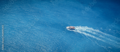Boat in the blue sea © PASTA DESIGN
