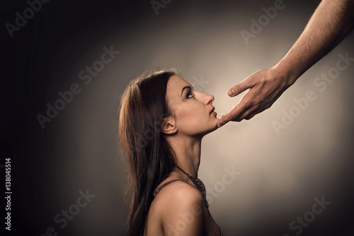Male hand touches to woman face as Sexual Harassment