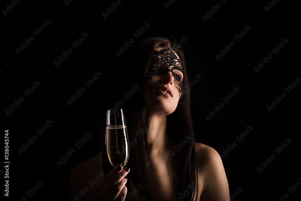 elegant lady portrait on black background dressed in mask and toasting elegant lady portrait on black background dressed in mask and toasting