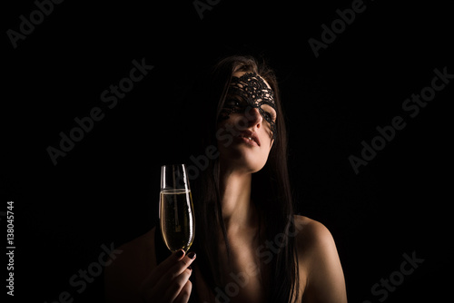 elegant lady portrait on black background dressed in mask and toasting © illustrissima