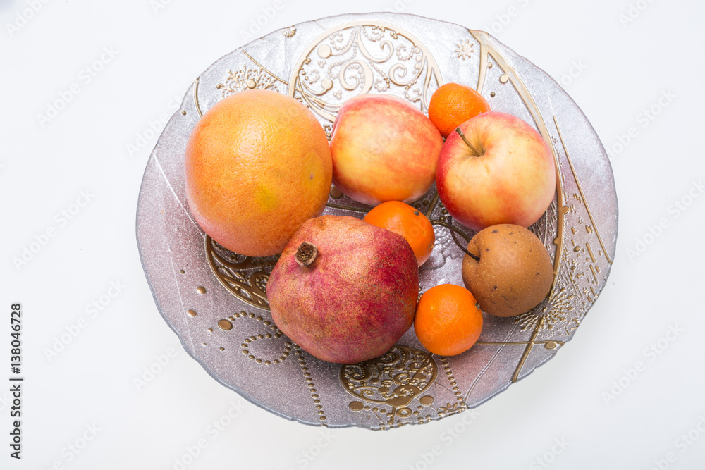 mix fresh fruits on plate isolated on white