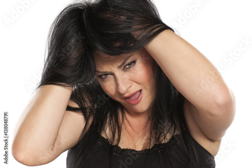 portrait of a young woman has an itch in her hair
