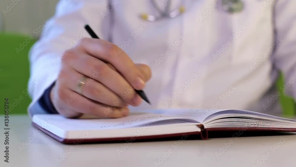 Therapist takes notes in a notebook Therapist takes notes in a notebook