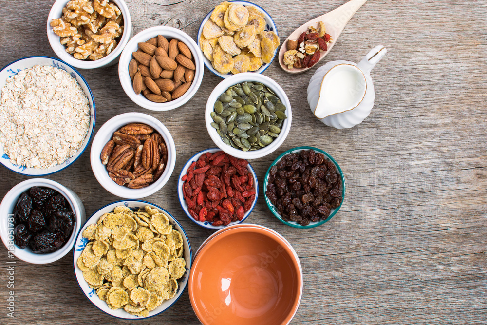 Ingredients for healthy granola: nuts, oats, cereals and dried fruits, top view, selective focus Ingredients for healthy granola: nuts, oats, cereals and dried fruits, top view, selective focus