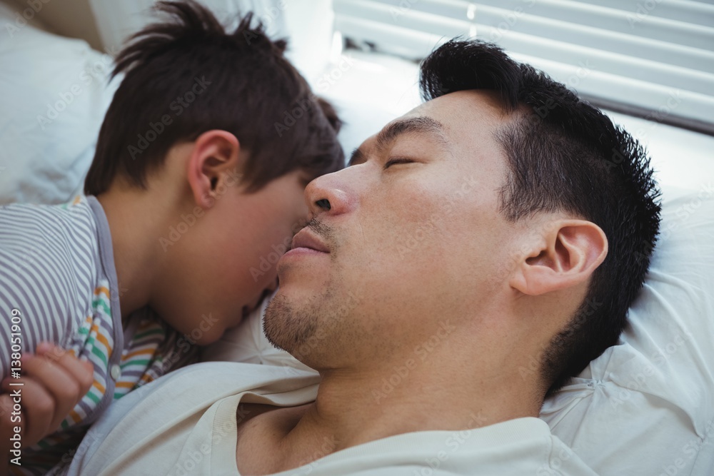Father and son sleeping together in bedroom Father and son sleeping together in bedroom