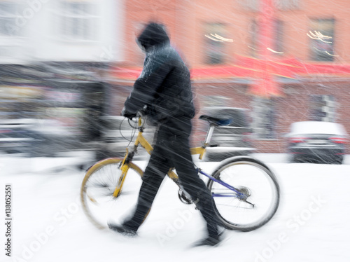 Man with bicycle in the city