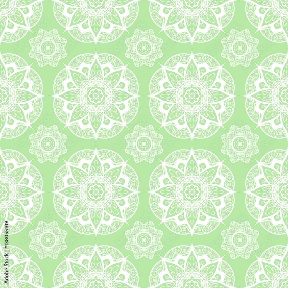 Seamless pattern of round white mandala on green background