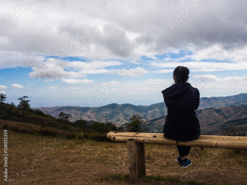 Young woman sitting on chair and see sky sit  alone