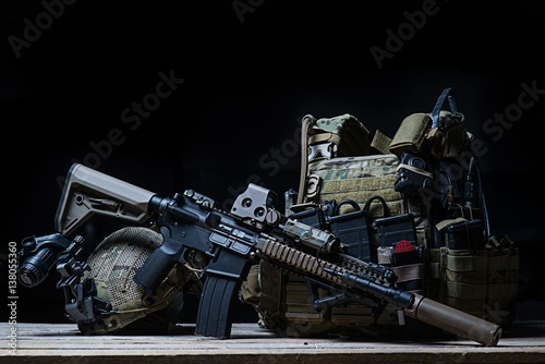 Rifle with silencer, bulletproof vest, helmet/Assault rifle with silencer, bulletproof vest, helmet with night vision device on dark background
