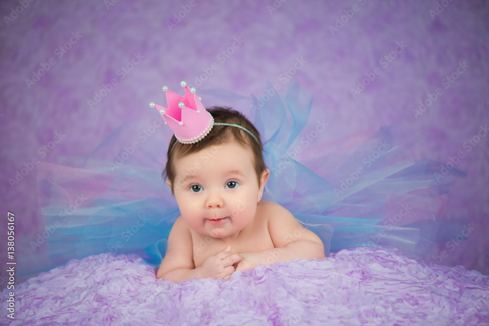 Portrait of newborn girl smiling in a pink crown Portrait of newborn girl smiling in a pink crown