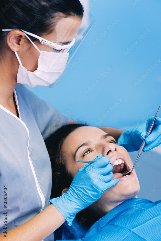 Dentists with a patient during a dental intervention. Dentists with a patient during a dental intervention.