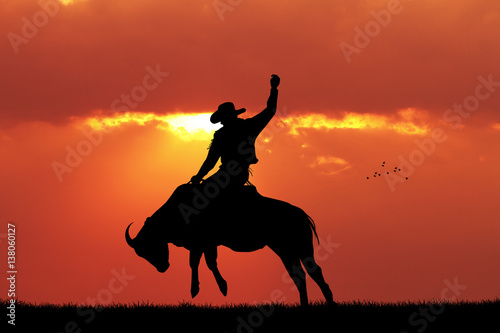 bull rider at sunset