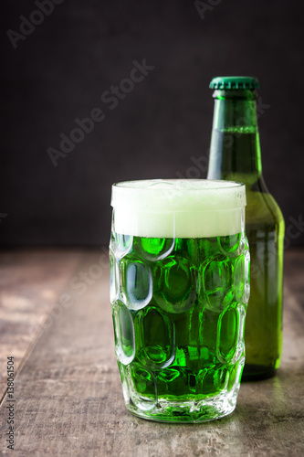 Traditional cold green beer for Saint Patrick's Day  on wooden background.Copyspace