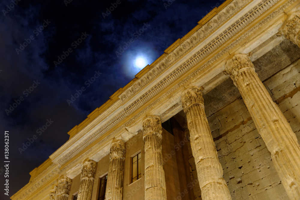 Naklejka premium Walk in Rome by night among ancient monuments.