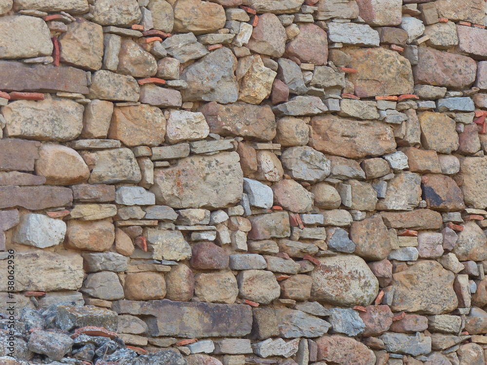 verfugte mediterrane Mauer aus Naturstein als Hintergrund 