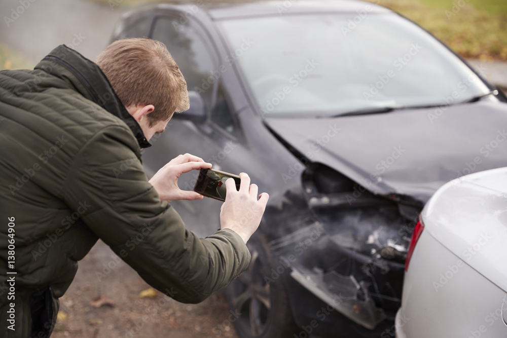 Man Taking Photo Of Car Accident On Mobile Phone Man Taking Photo Of Car Accident On Mobile Phone